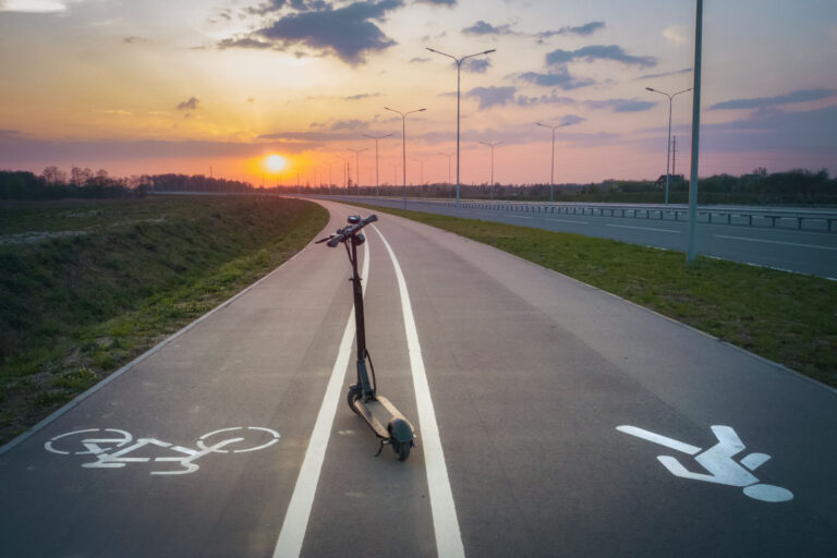 en electric scooter in middle of the road during sunset